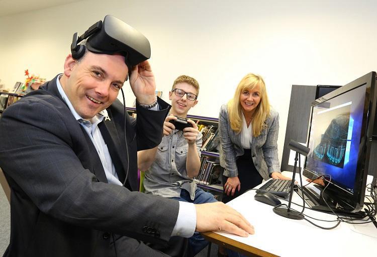 Minister Robert Halfon with games student Cameron Knotts and Judith Doyle of Gateshead College