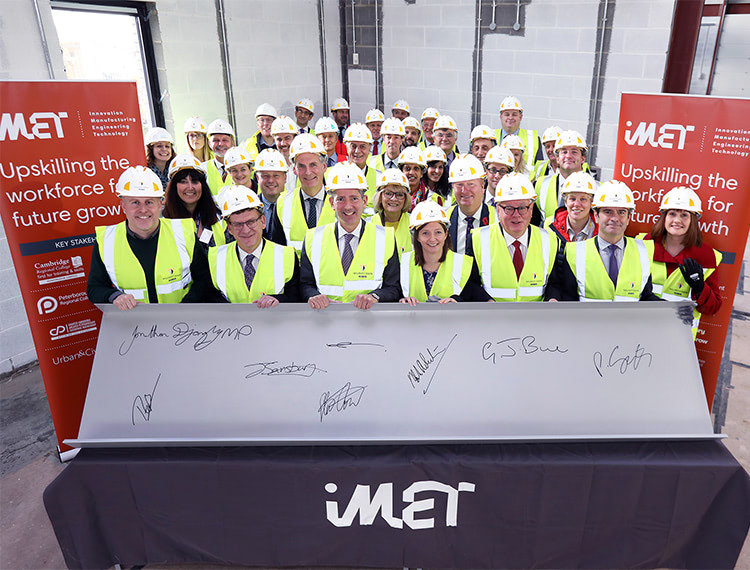 Huntingdon MP Jonathan Djanogly formally topped out the building by signing a roof coping. He is pictured with guests including Paul Sayles, Mark Robertson, Robin Butler, Joanne Sainsbury, Cllr Steve Count, Cllr Graham Bull and Terry Jones