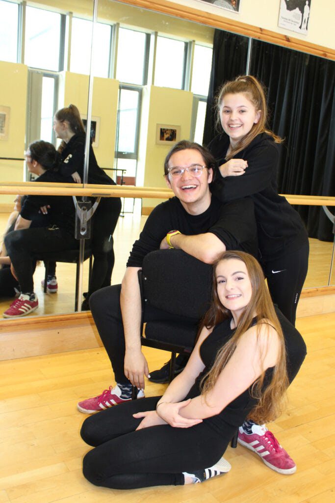 Cara Cossey (top), William Phillips and Sophie Tucker (bottom) celebrate in the dance studio at Tresham College.
