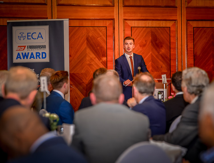 Jack Teasdale of Opus Building Services, and 2018 ECA Edmundson Apprentice of the Year, presents a speech during an awards ceremony at the Copthorne Tara Hotel, London