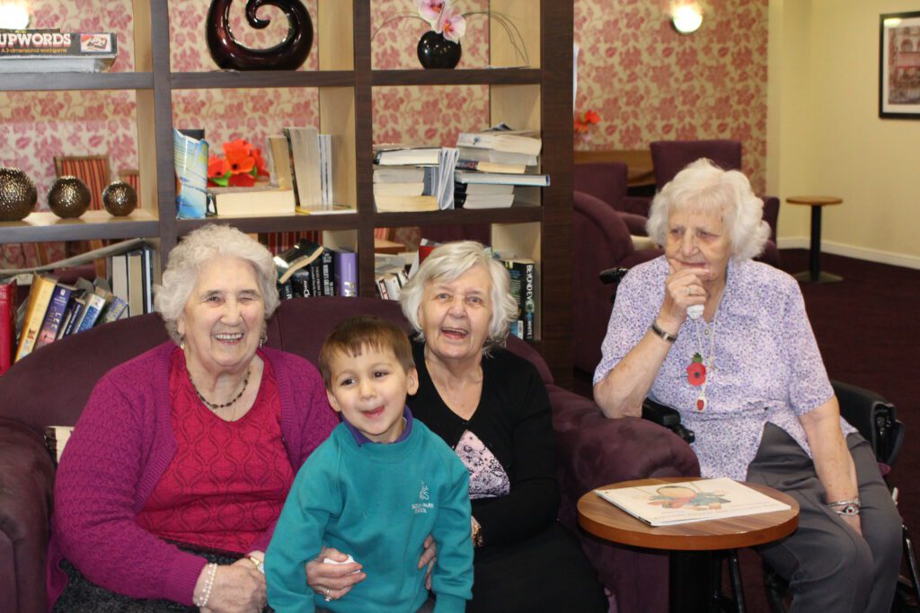 Bickley Park School nursery attendee with residents of Crown Meadow Nursing Home.