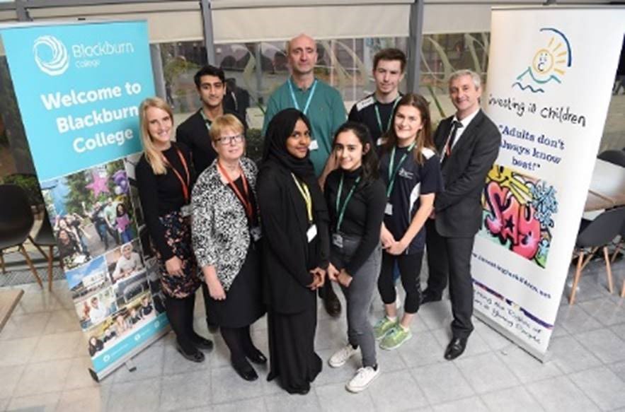 Pictured is Rob Johnson, Project Manager for Investors in Children with students and staff members who helped support the award. Students pictured are: Rumana Jeru, Leah Rhodes, Rahma Mansur, Hassan Ghani and Jon Burke.