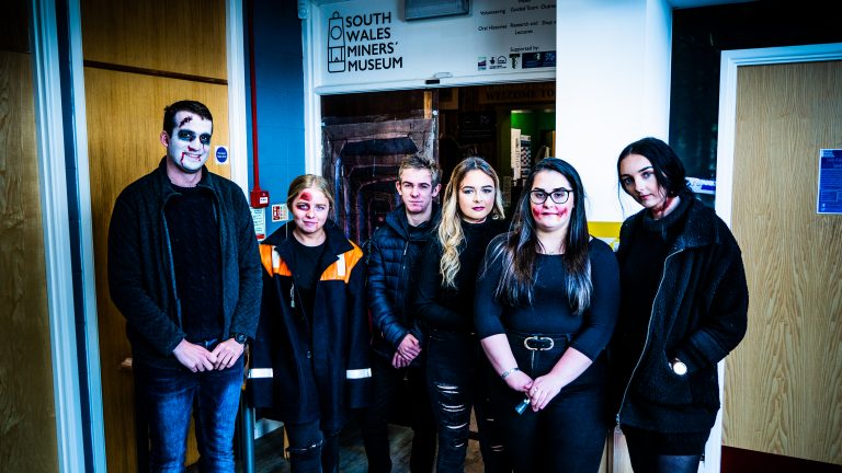 First-year Travel and Tourism students and Will Sims at the entrance to the haunted mine at their Halloween event.