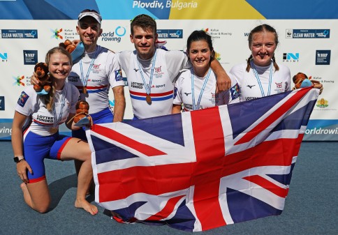 Ellen Butrick (far right) with her teammates winning gold at the World Championships. Photo credit: British Rowing/Naomi Baker