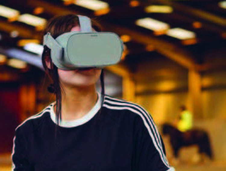 Student using a VR headset on a farm