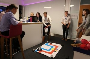 Work experience students getting to grips with robotics.