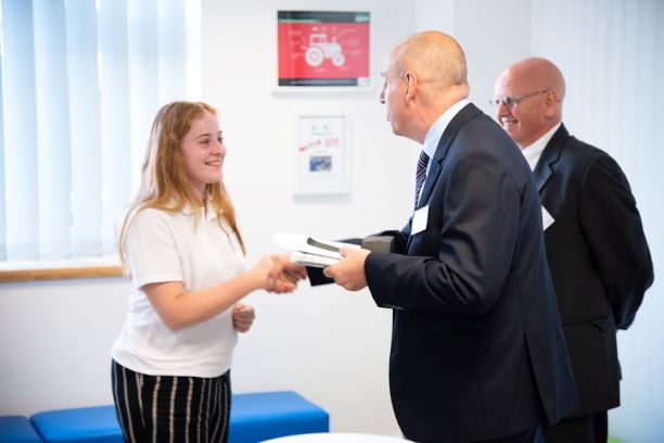 Brand new Apollo apprentice, Iona, receives her welcome pack from Apollo MD, Paul Clements.