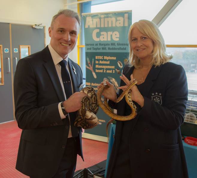 Huddersfield Town’s Commercial Manager – Partnerships, John Williams and Huddersfield Town’s Senior Commercial Manager – Hospitality, Tracy Nelson pose with some of Kirklees Colleges resident reptiles.
