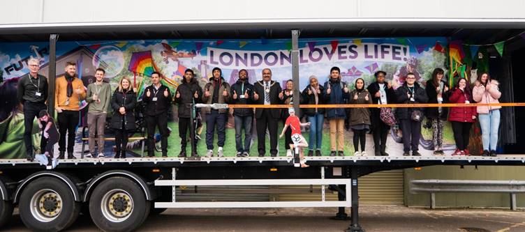 The Mayor of Barking & Dagenham Cllr. Peter Chand taking part in a secret unveiling of the float with the college students and staff who worked on it