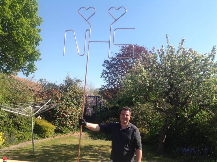 Plumbing lecturer Darren Myler from Barking & Dagenham College has created a giant NHS sign from pipes, which is on display outside his home