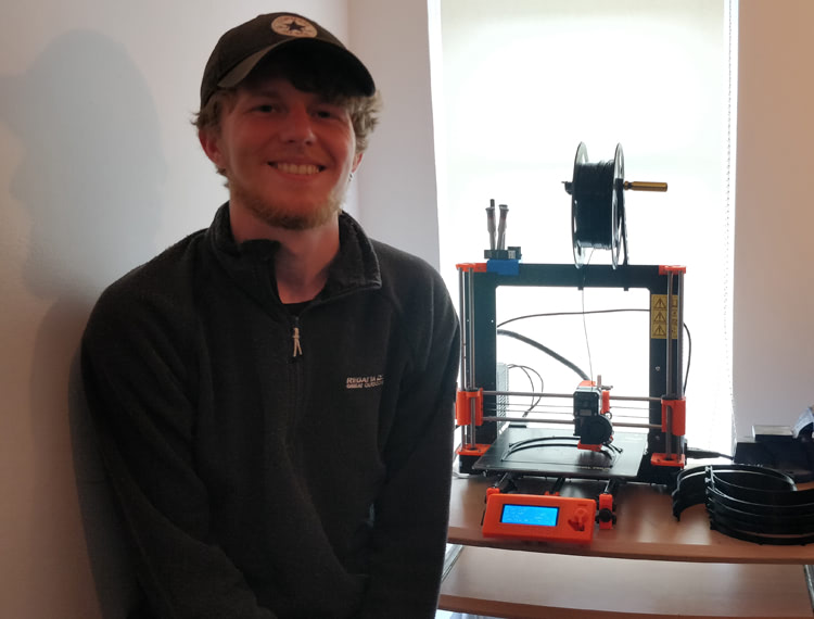 SERC Industrial Engineer, Christopher Bell, from Newtownards, who has been working away to support the health service by manufacturing face shields using one of SERCS’s 3D printers at home.