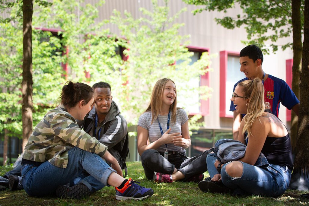 Students sitting together outside having a laugh