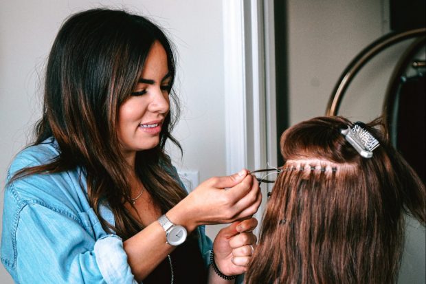 Teenager practising hairdressing on a model