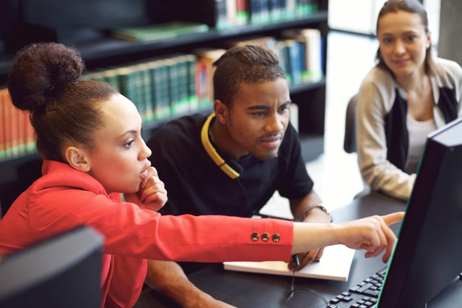 Students learning pointing at a screen