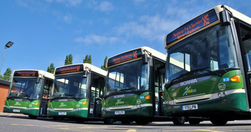 Green buses in a line