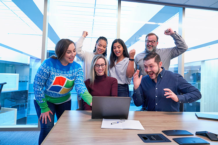 Cheering colleagues, someone wearing a windows jumper