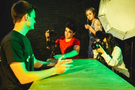 Students filming on a set