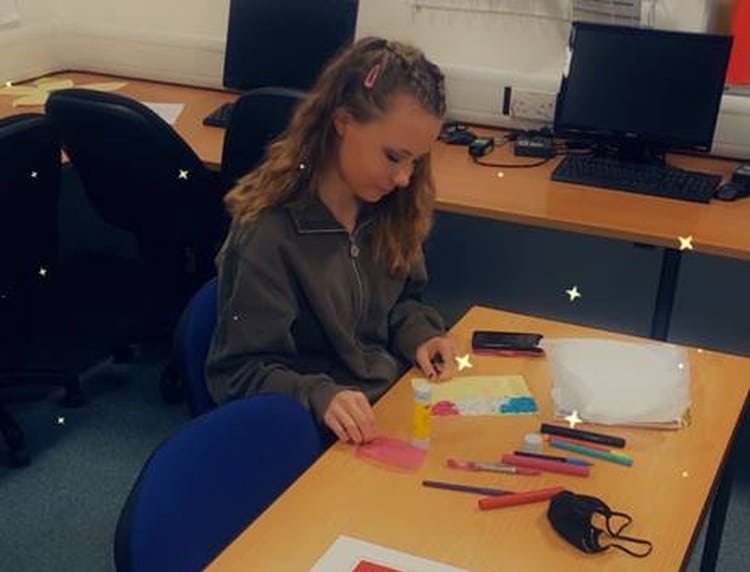 A Level 1 Health and Social Care student making a Christmas card.