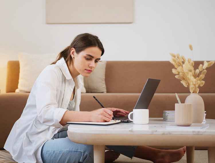 Lady working on her laptop at home