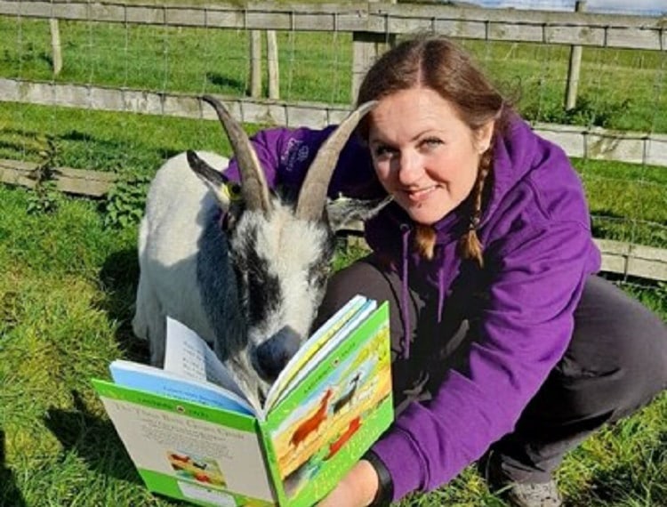 Lindsey Robinson, reading to a goat