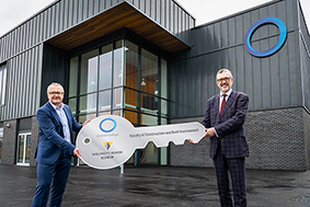 Handing over the keys outside Oldham College