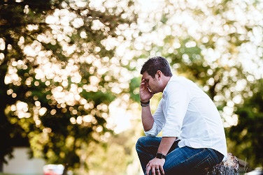 A man looking stressed outside