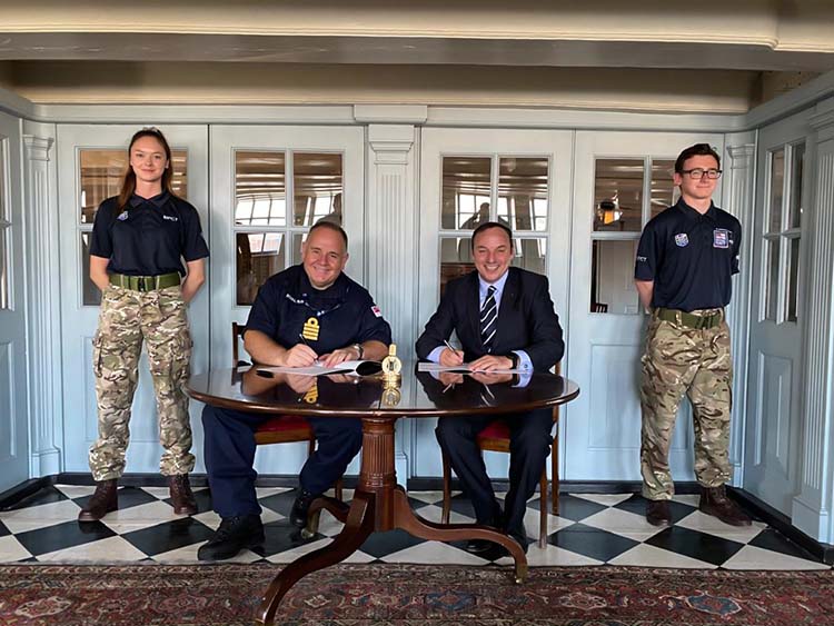 Captain Pete Viney, the Royal Navy's director of Recruitment and Attraction and MPCT CEO Huw Lewis sign the Memorandum of Understanding on the deck of HMS Victory