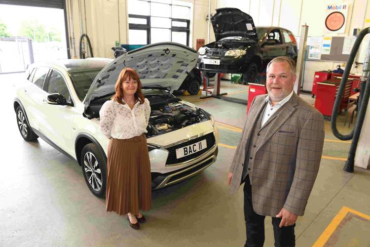 Outgoing Chair of Bishop Auckland College Corporation Pamela Petty with new Chair Patrick Lonergan in the college’s motor vehicle technology workshop. Photo by Barry Pells.