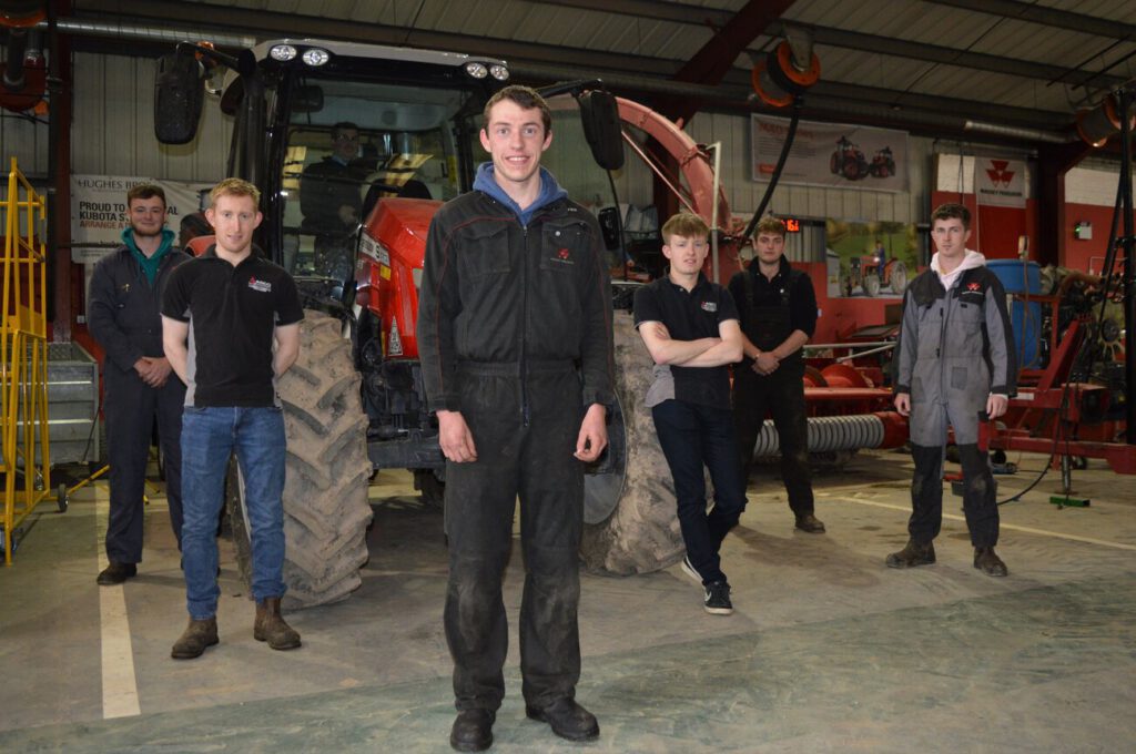 students stood in front of tractor