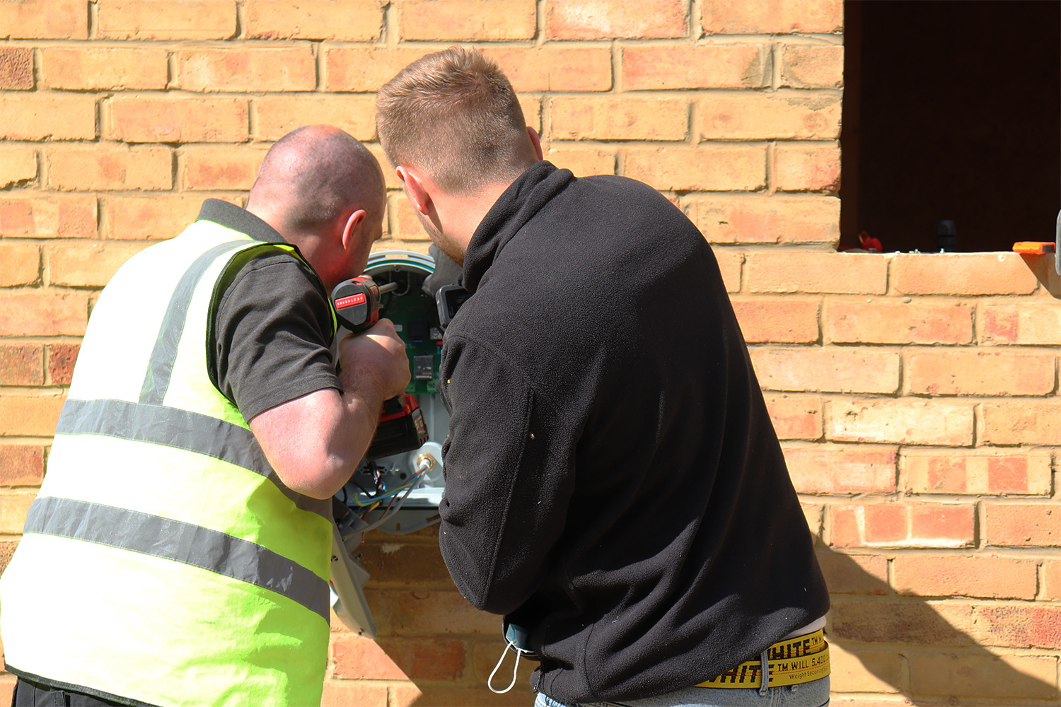 two men drilling a wall