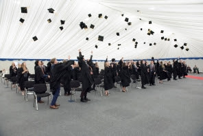 students throwing hats in the air