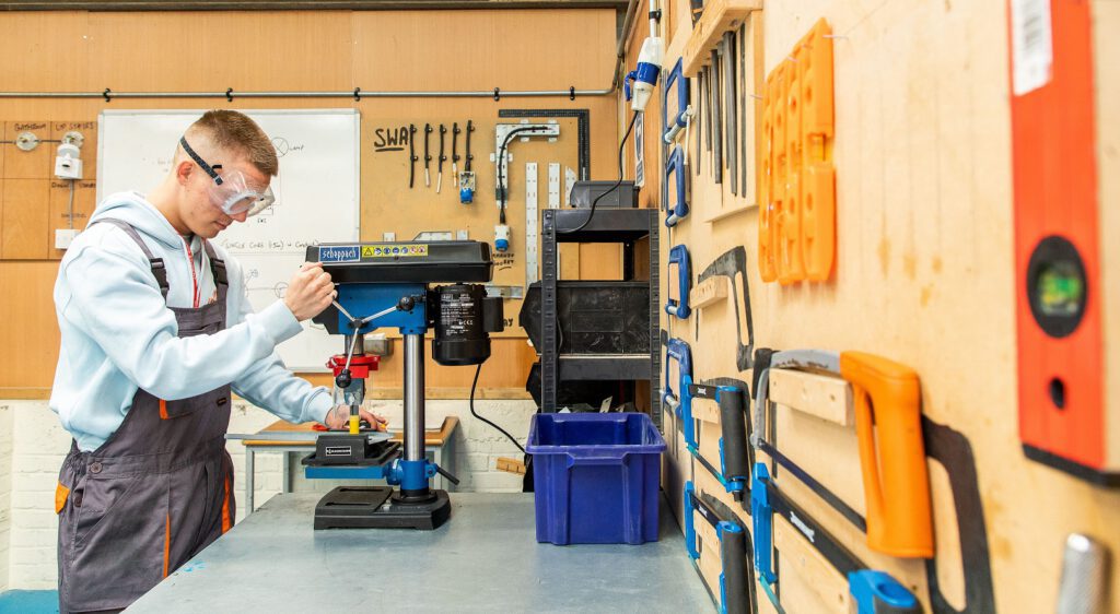 student working on a machine