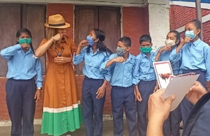 Girls with hearing impairment teach Helen Grant MP how to sign the word ‘cow’ in Nepali Sign Language, Adarsa Adhabhut Primary School, Khajura LG