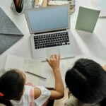 Child with adult on laptop