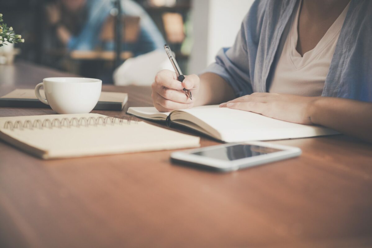 Person at desk writing