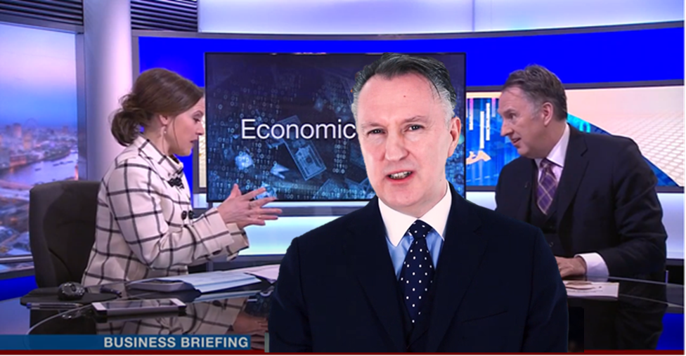Image of BBC television news studio with Guildhawk director David Clarke speaking to female presenter and Guildhawk Voice multilingual avatar of Clarke in foreground for article about the future of Artificial Intelligence AI technology using ultra-pure data lakes
