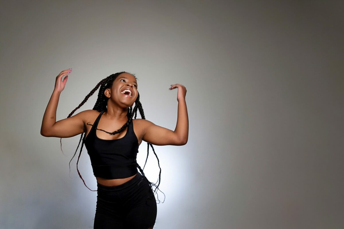 student flicking hair with arms in air