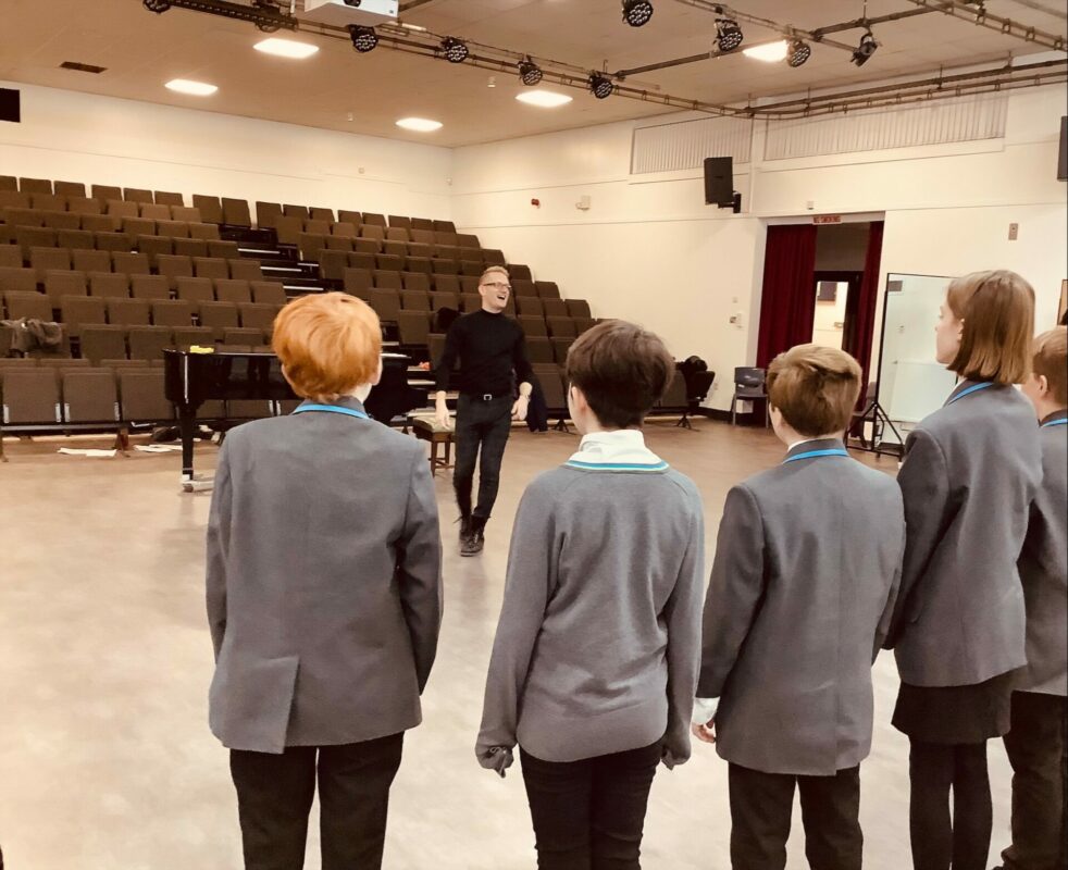 Acclaimed British Tenor Charles MacDougall coaching The Hart School's choir in a recent workshop.