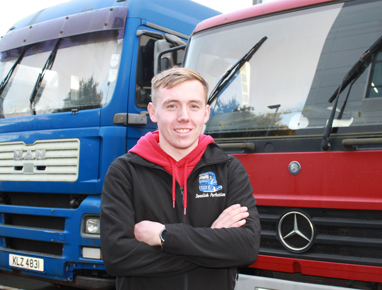 Ciaran stood in front of two lorries