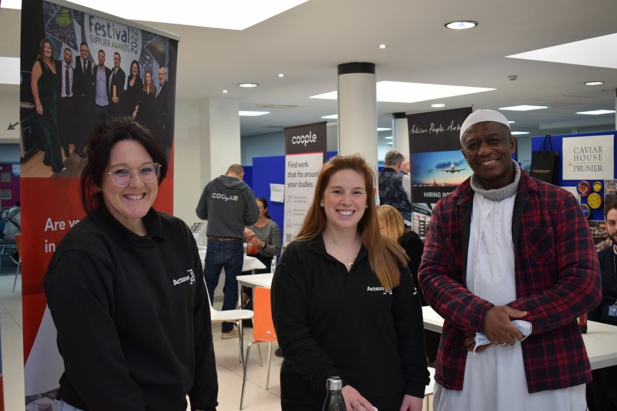 Pictured: Sol Hernandez (left) and Emily Kenward from Actavo with a visiting jobseeker at Jobs Fair Spring 2022.