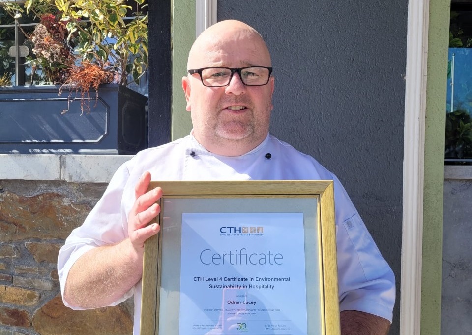Odran Lucey, executive chef holding his framed CTH Level 4 Certificate in Environmental Sustainability in Hospitality.