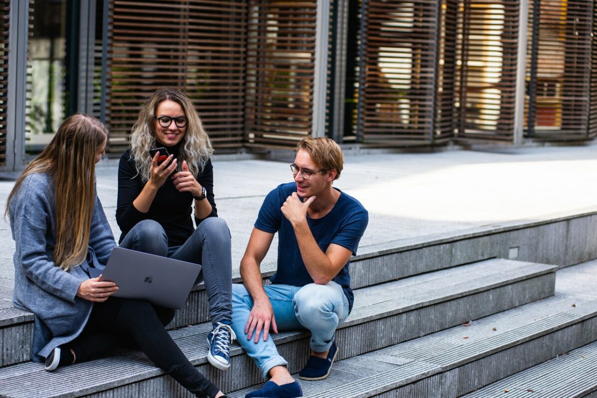 students on stairs with laptop