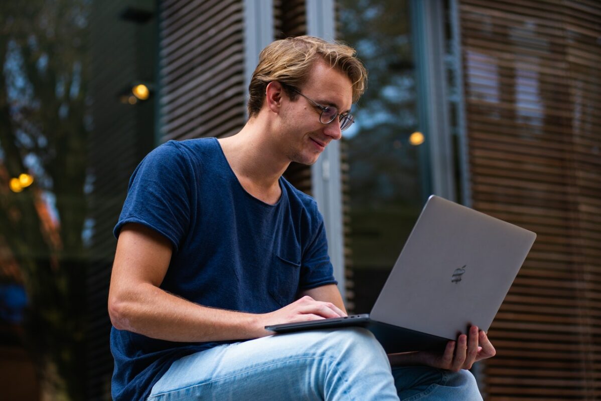 Male sat on computer