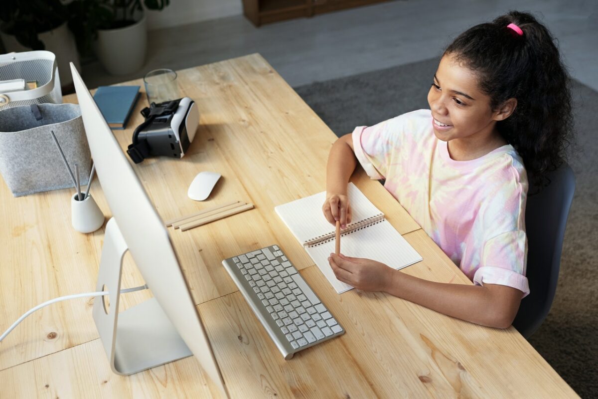 young female smiling looking at computer