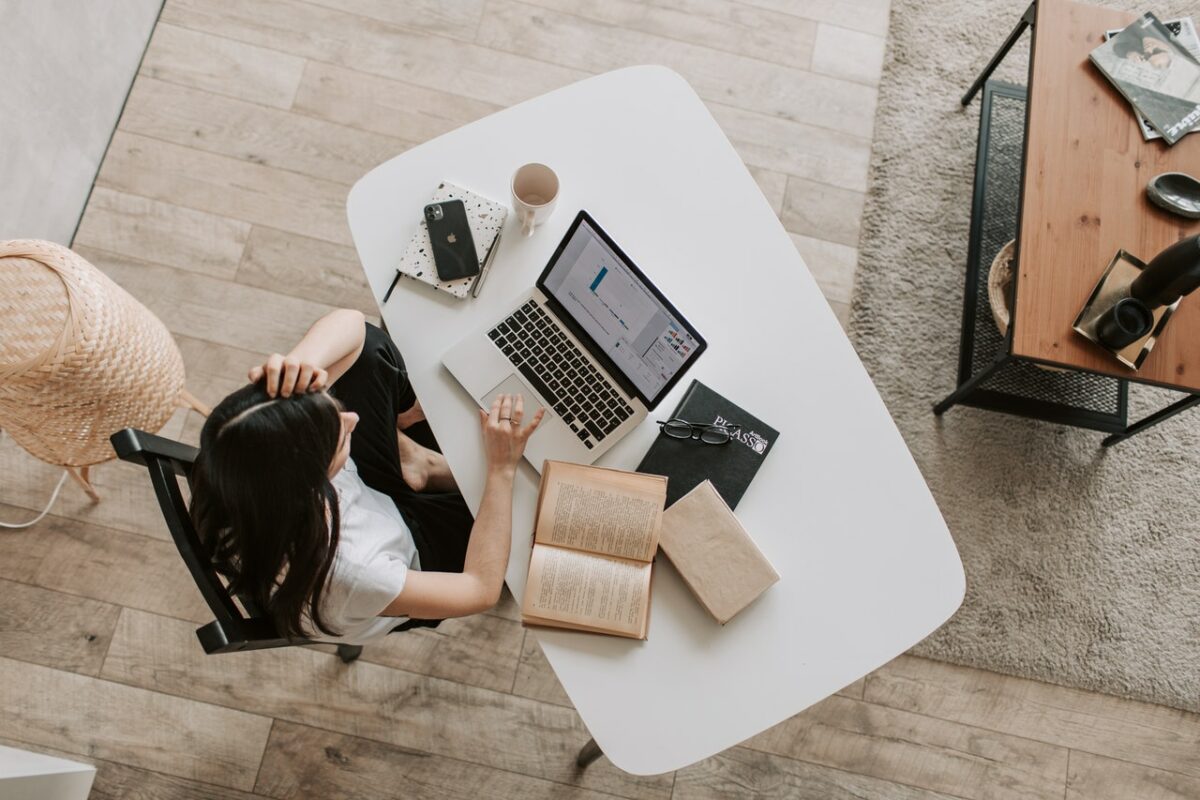 birds eye view of woman sat at desk with laptop