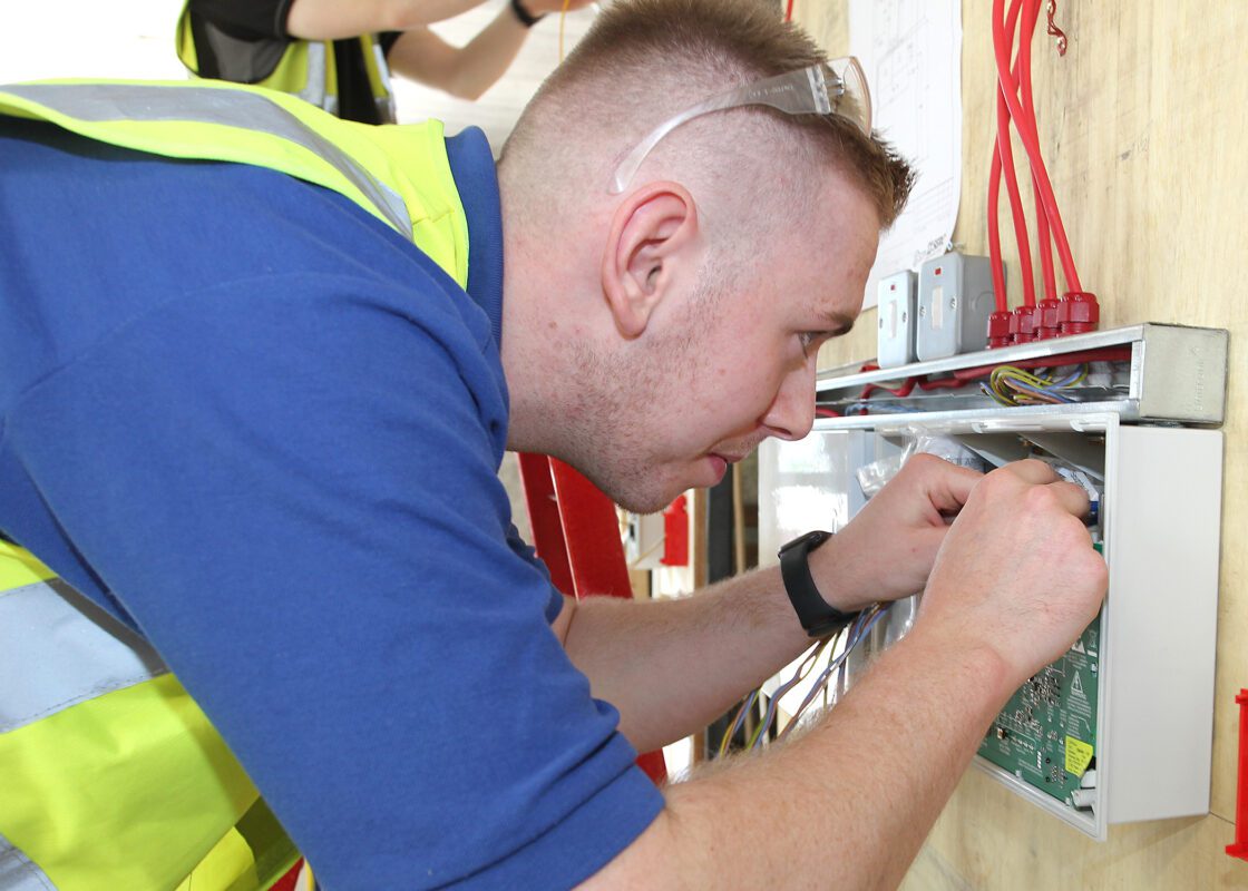 Apprentice working on fire systems unit