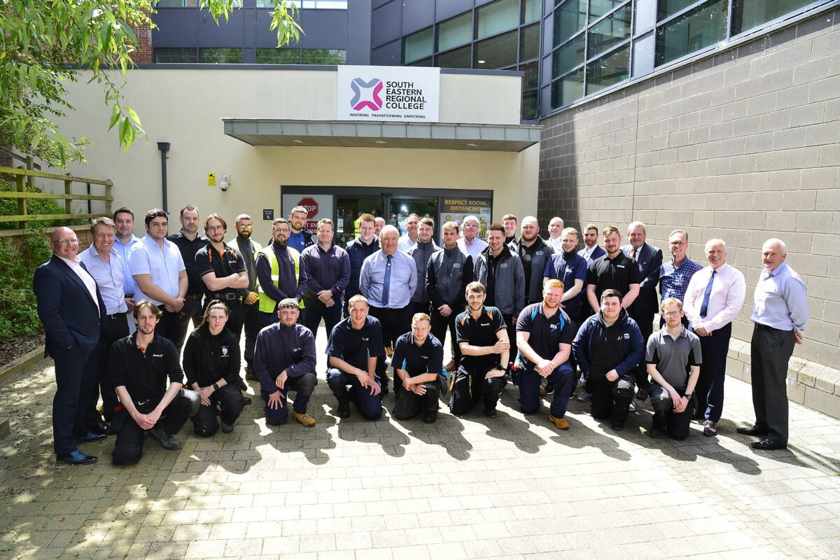 Group of 25 fire and security apprentices pictured with employers outside South Eastern Regional College Lisburn Campus