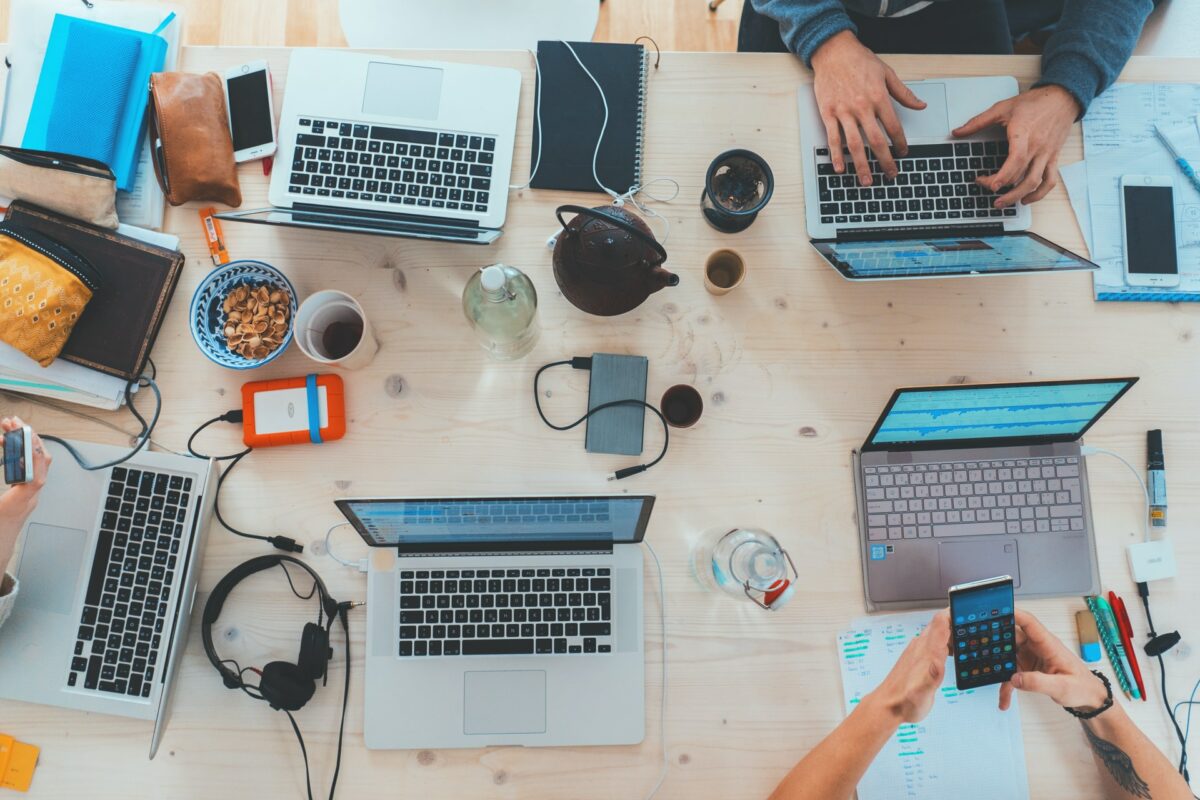 social media - shot of laptops and phones co-working