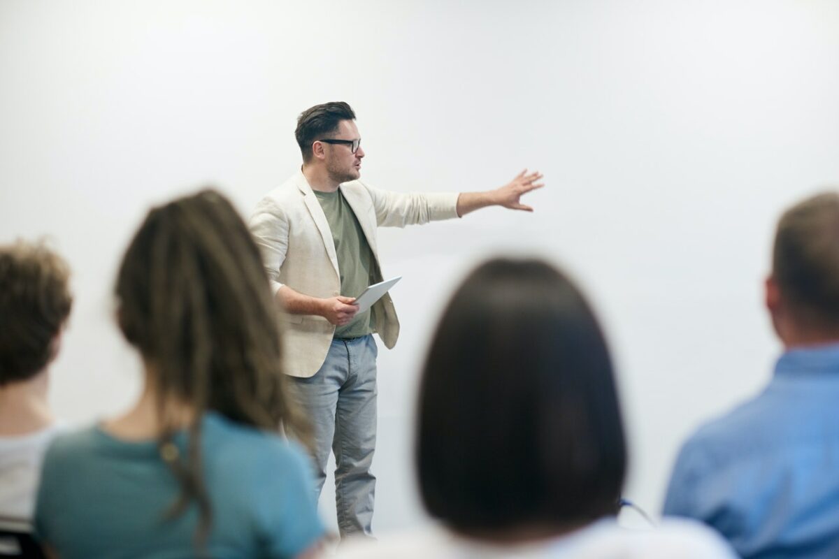 Teacher in front of whiteboard with students