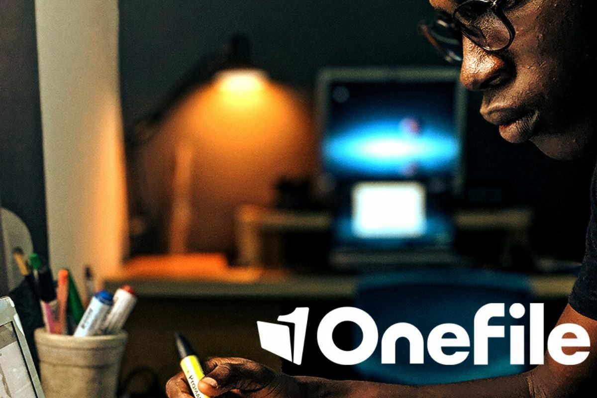 Onefile, man looking at laptop